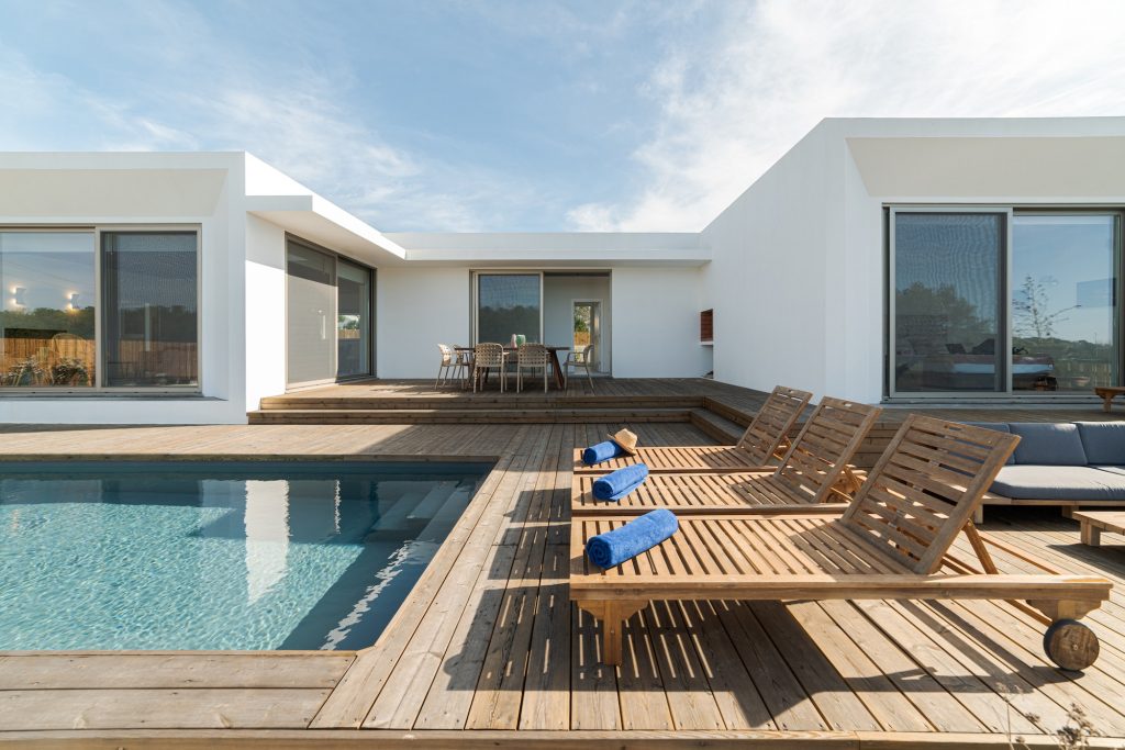 Lounge chairs in modern villa pool